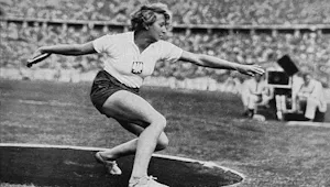 A black and white photo of an Olympic competitor