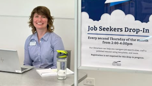 A librarian sitting at a table