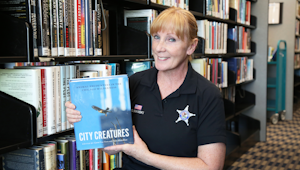 Gina Manski holds an animal book
