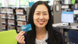 A person holding a library card