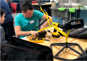 Volunteer repairing a mechanical toy