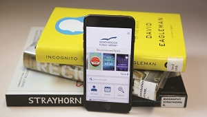 Photo of the library app on a stack of books