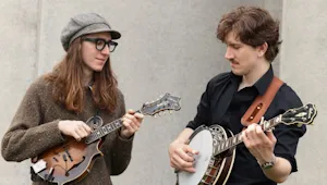 Two men playing banjos