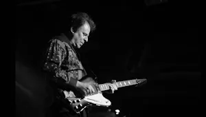 A man playing a blues guitar