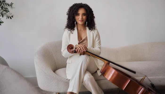 A photo of cellist Anita Graef holding her cello