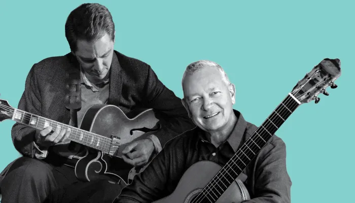 A photo of Andy Brown and Christopher Laughlin holding guitars