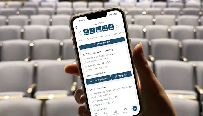 A person's hand holding a phone showing the library app 