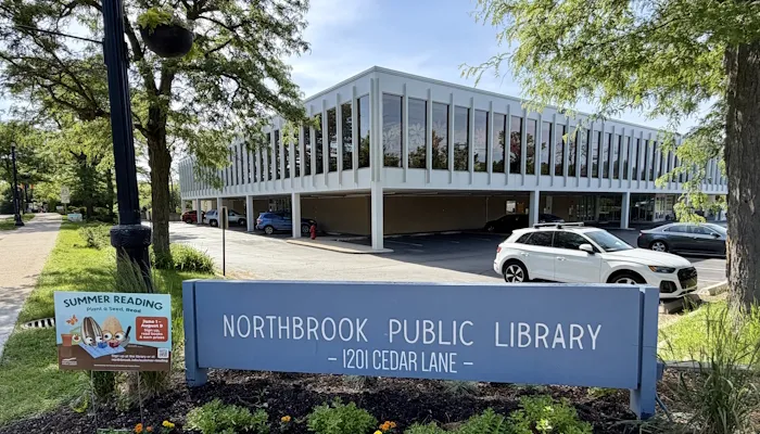 The library sign and a Summer Reading yard sign